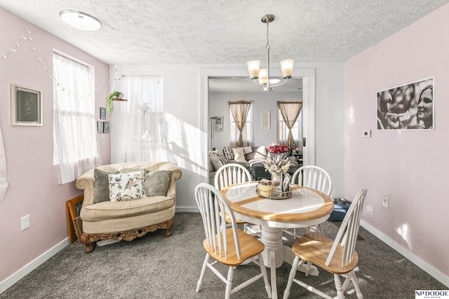 carpeted dining space with a notable chandelier and a textured ceiling