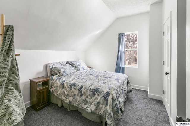 bedroom with lofted ceiling, carpet floors, and a textured ceiling