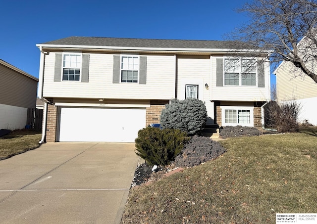 split foyer home featuring a garage and a front lawn