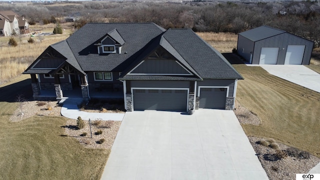 craftsman-style house featuring a garage, a front lawn, and covered porch