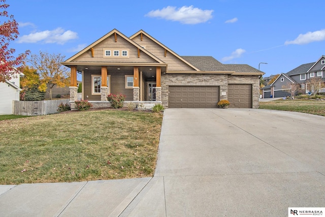 view of front facade featuring a garage, covered porch, and a front lawn