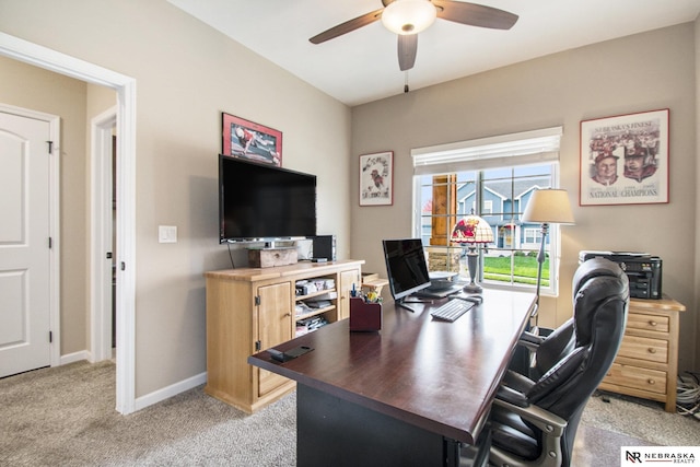 carpeted office space with ceiling fan