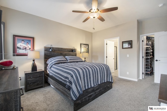 bedroom with ensuite bath, ceiling fan, carpet flooring, a spacious closet, and a closet