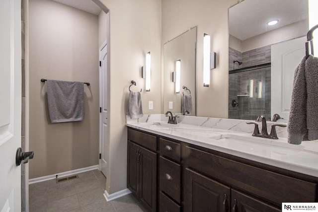 bathroom featuring an enclosed shower, vanity, and tile patterned floors