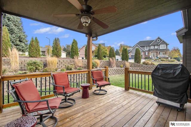 wooden deck featuring grilling area and ceiling fan