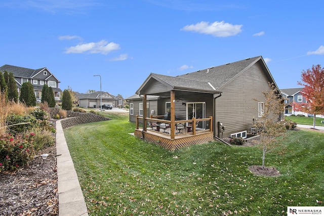 rear view of house featuring a lawn