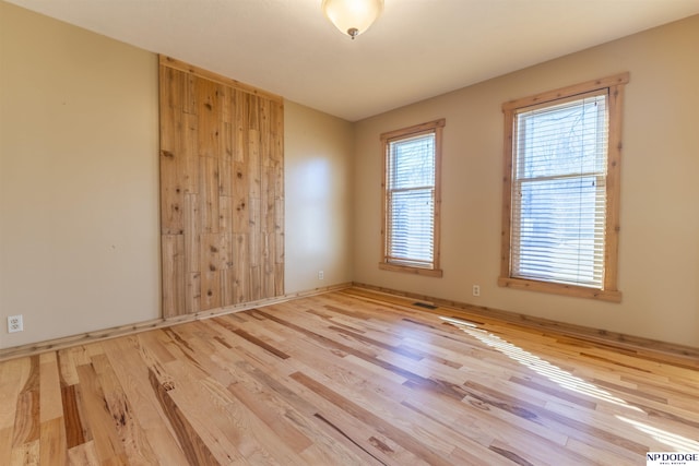 unfurnished room with light hardwood / wood-style flooring