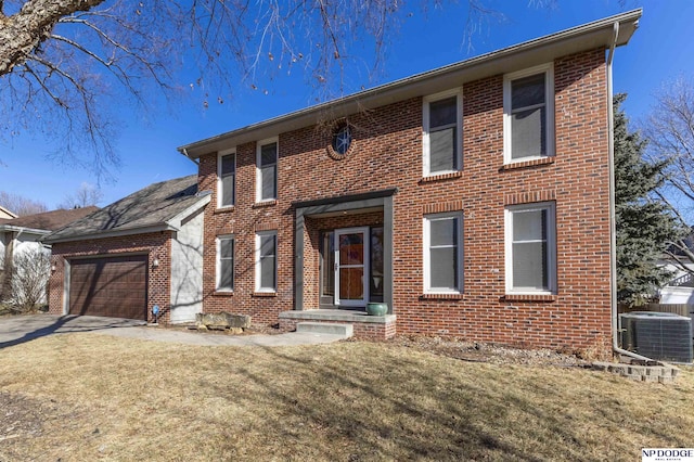 view of front of property with a garage, central AC, and a front yard