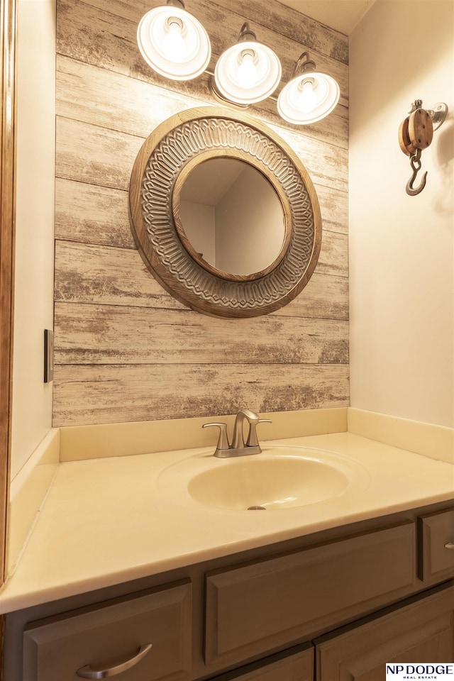 bathroom with vanity and wooden walls