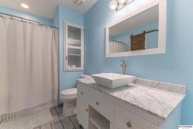 bathroom with tile patterned flooring, vanity, and toilet