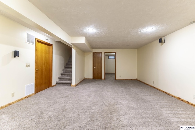 basement with carpet flooring and a textured ceiling