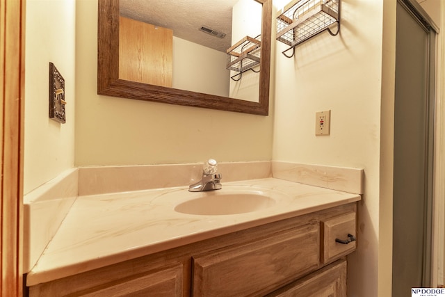 bathroom featuring vanity and a textured ceiling