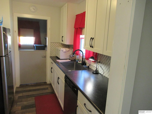 kitchen with white cabinetry, sink, decorative backsplash, and stainless steel appliances