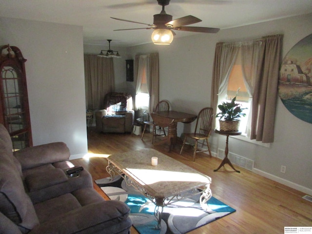 living room featuring ceiling fan, plenty of natural light, and light wood-type flooring