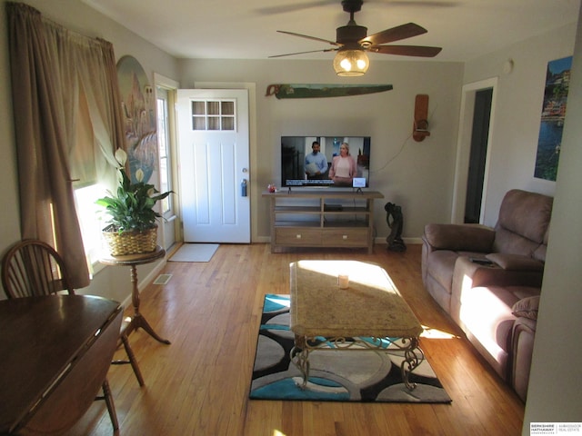 living room with ceiling fan and light hardwood / wood-style floors