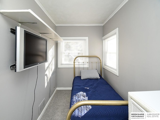 bedroom featuring multiple windows, crown molding, and carpet floors