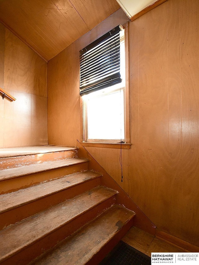 stairway with wood ceiling