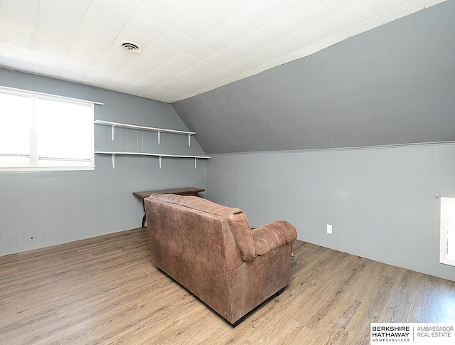 interior space featuring lofted ceiling and light hardwood / wood-style flooring