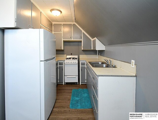 kitchen with dark hardwood / wood-style flooring, lofted ceiling, sink, and white appliances