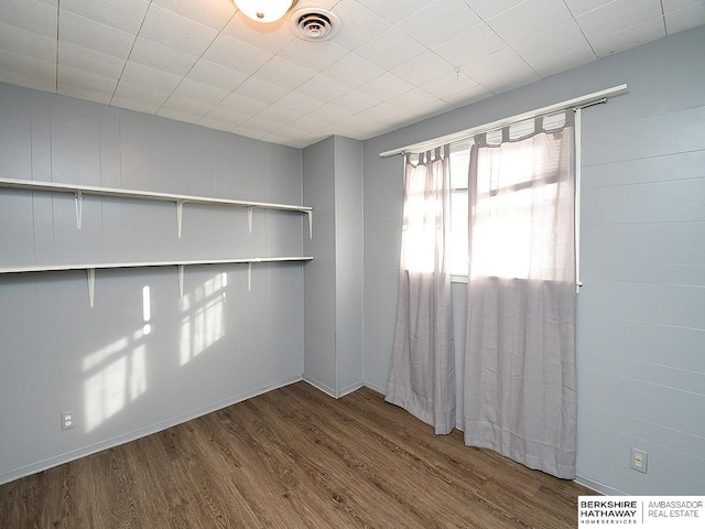 empty room with hardwood / wood-style flooring