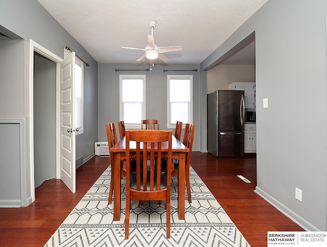 dining area featuring dark wood-type flooring and ceiling fan