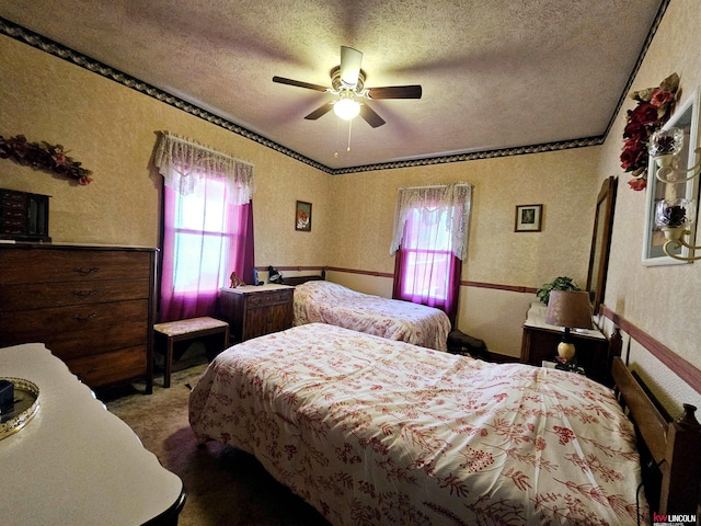 bedroom with carpet flooring, a textured ceiling, and wallpapered walls