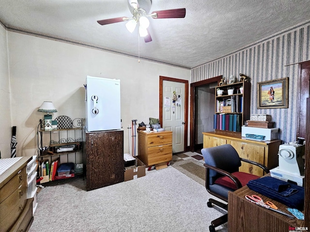 home office featuring a ceiling fan, light colored carpet, a textured ceiling, and wallpapered walls