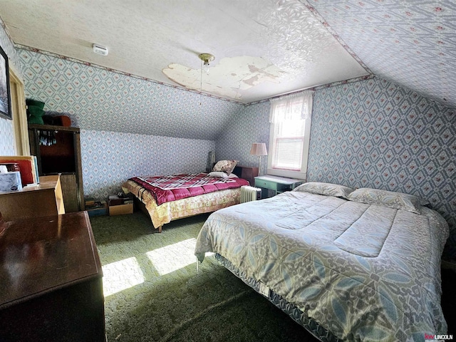 bedroom featuring vaulted ceiling, carpet floors, a textured ceiling, and wallpapered walls