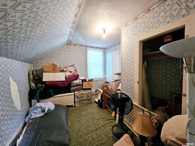 carpeted bedroom featuring lofted ceiling, a textured ceiling, and wallpapered walls