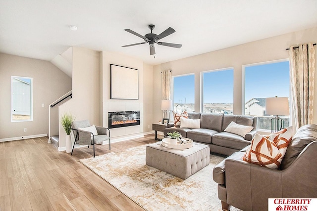 living room with ceiling fan and light wood-type flooring