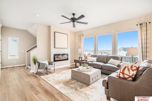 living room with light hardwood / wood-style flooring and ceiling fan