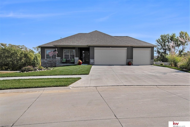 prairie-style home featuring a garage and a front yard