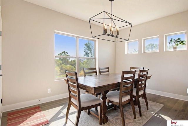 dining space featuring an inviting chandelier, wood-type flooring, and plenty of natural light