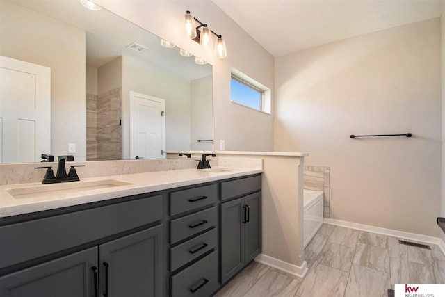 bathroom featuring vanity and a tub to relax in