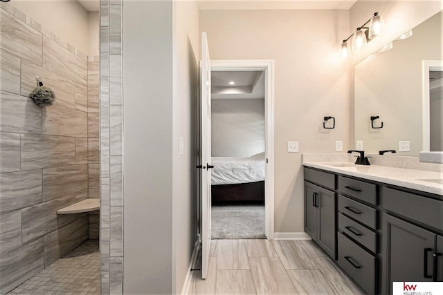 bathroom with vanity and tiled shower