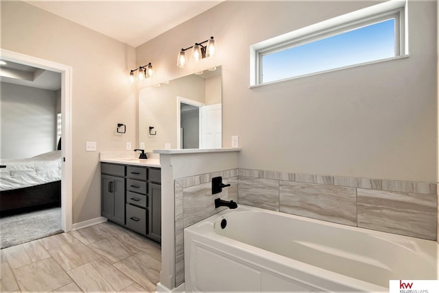 bathroom featuring a tub to relax in and vanity