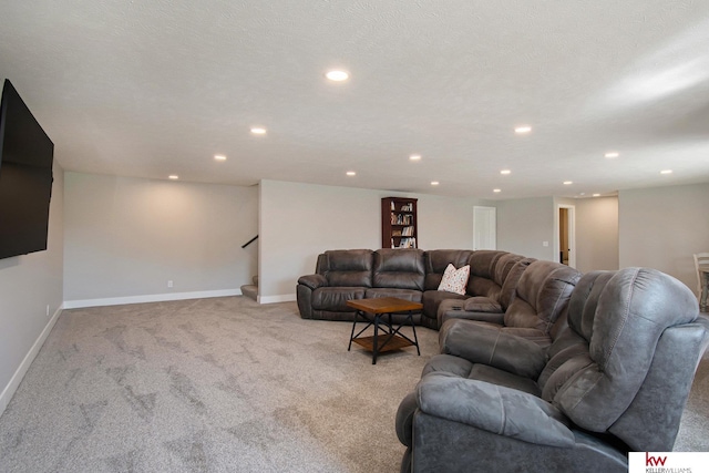 carpeted living room featuring a textured ceiling