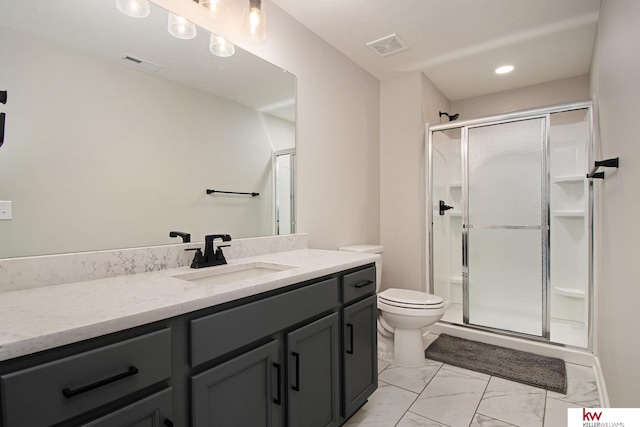 bathroom with vanity, an enclosed shower, and toilet