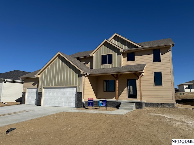 view of front facade featuring a porch and a garage