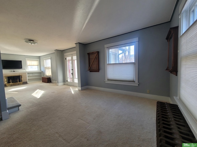 unfurnished living room with carpet flooring and french doors