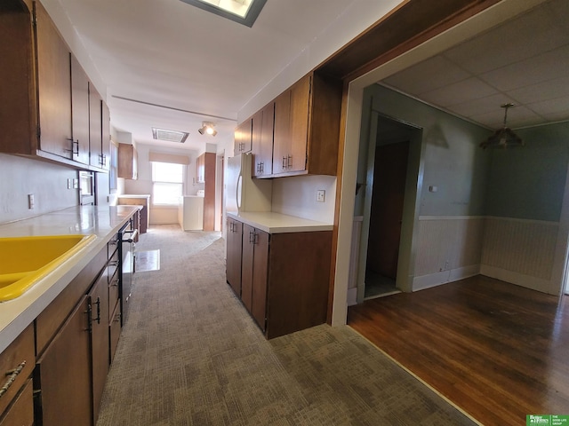 kitchen with sink, dark hardwood / wood-style floors, and white refrigerator