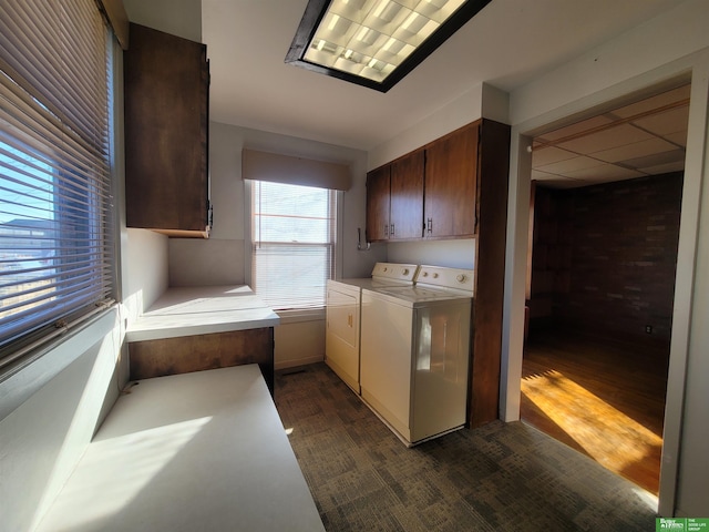 washroom featuring separate washer and dryer and cabinets