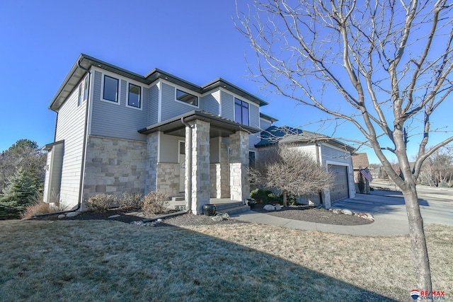 view of front of house featuring a garage and a front yard