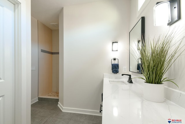 bathroom with a shower and vanity