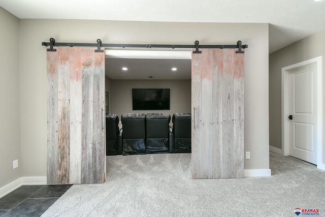 carpeted spare room with a barn door