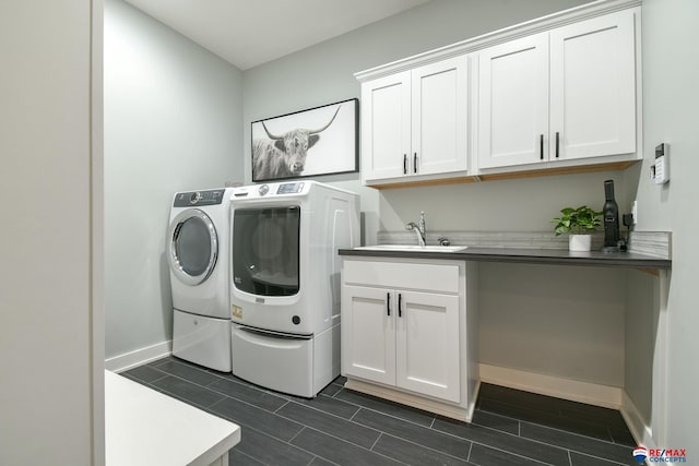 washroom with sink, cabinets, and independent washer and dryer