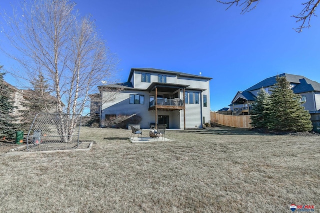 rear view of house with a lawn and a patio area