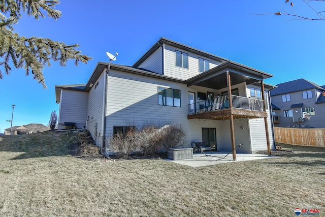 rear view of property with a yard and a patio