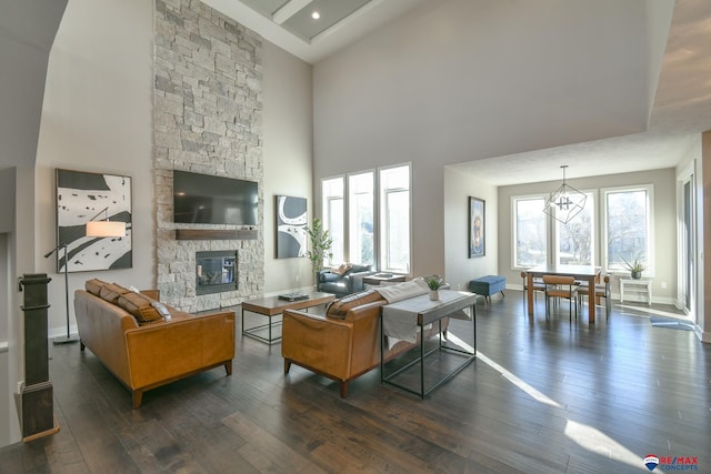 living room featuring a fireplace, dark hardwood / wood-style floors, and a high ceiling