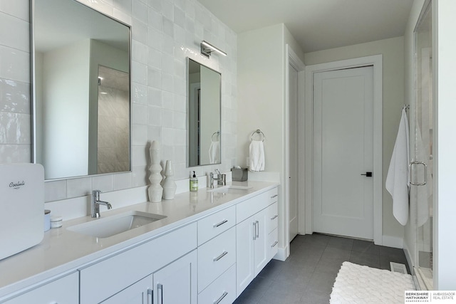 bathroom featuring tile patterned flooring, vanity, and tile walls